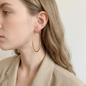 Minimalist large gold hoop earrings for women shown from a high-quality side profile view