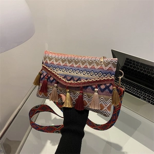 Bohemian tapestry crossbody bag with colorful tassels and geometric ethnic patterns