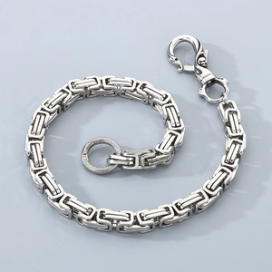 Detailed close-up of stainless steel Cuban link chain with lobster clasp and textured ring