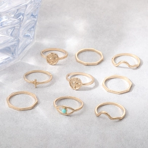 9-piece gold ring set featuring celestial stars, wave patterns, and turquoise eye accents