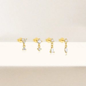 Detailed view of four gold S925 silver stud earrings with marquise and round zircon stones