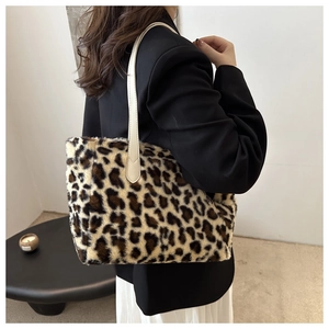 Detail shot of leopard print plush tote bag with white leather straps on a model