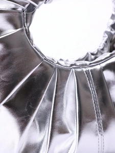 Detail of silver metallic cloud bag featuring precise pleated design and glossy PU leather