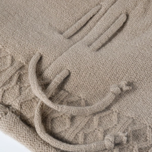 Winter oatmeal knit slouchy beanie featuring detailed cable pattern and drawstring detail