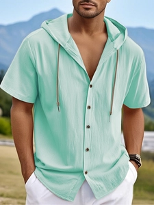 Close-up of mint green cotton linen short sleeve hooded shirt with button detailing