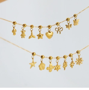 Close-up of gold stainless steel necklaces with heart, butterfly and star charms