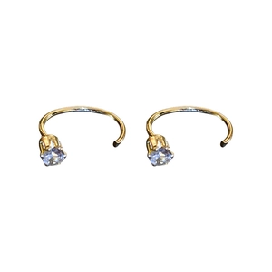 Minimalist gold hoop earrings with purple zircon stones shown in a symmetrical layout