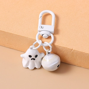 Close-up of a 3D white ghost keychain with matching bell and metal clasp