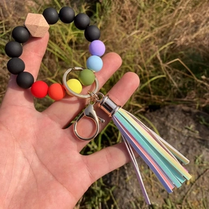 Detail of colorful silicone beaded keychain with wooden hexagon bead and tassel pendant
