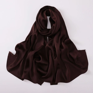 Detail shot of draped dark brown chiffon shawl with a smooth and glossy texture