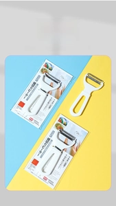 Close-up of dual stainless steel blade peeler with Japanese retail card packaging