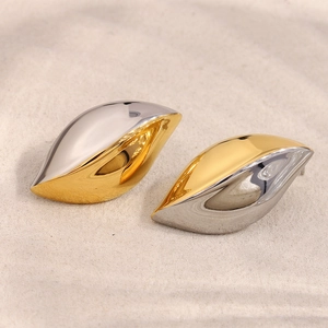 Detail of creative teardrop flame earrings in 18K gold and silver two-tone polished finish