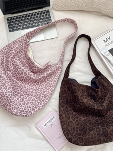 Large leopard print suede tote bags in pink and brown on a white lifestyle background