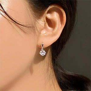 Elegant 925 sterling silver four-prong zircon teardrop earring worn by a model