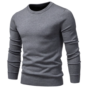 Close-up of grey crewneck sweater showing detailed knit texture and ribbed cuffs