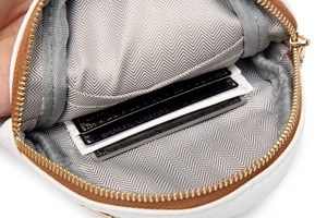 Detail of white faux leather crossbody bag with three card slots and fabric lining