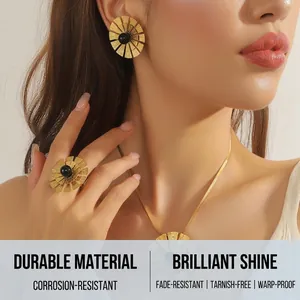 Macro view of gold-plated flower jewelry set with black inlay on model skin