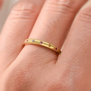 Macro shot of s925 silver gold ring with colorful zircon stones worn on finger