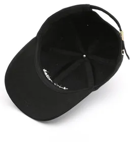 Detailed interior view of black cotton baseball cap showing stitching and metal buckle