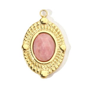 Detailed macro view of a vintage oval gold pendant with pink natural stone inlay