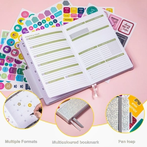 Detailed view of undated planner with colorful stickers, bookmarks and pen loop features