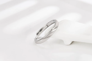 Detailed shot of polished silver open ring featuring a sparkling zircon diagonal inlay