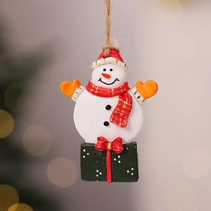 Close-up of a festive resin snowman ornament with a red hat and vintage holiday vibe
