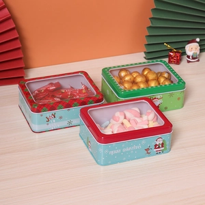 Three Christmas tin boxes with transparent windows for candy and gift packaging