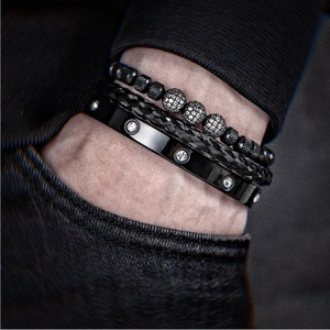 Detail of luxury men's black beaded and braided bracelet set with crystal accents