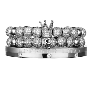 Macro detail of Forever Love engraved stainless steel bracelet set with zircon stones