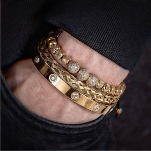 Close-up of gold stainless steel mesh bracelets set with crystal beads on a male wrist