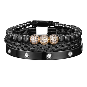 Close-up of black beaded, woven and smooth metal bracelet set with golden diamond accents