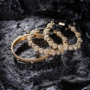 Detail of Forever Love engraved gold bangle and micro-pave crown beaded bracelet