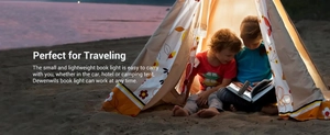 Mini portable clip-on reading light used by children inside a tent at night