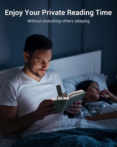 Man reading in bed using a portable clip-on light for private night reading