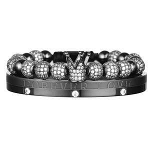 Detailed close-up of crown charm bead bracelet and Forever Love engraved metal bangle