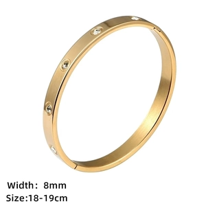 Detail view of 8mm gold stainless steel bangle with screw design and crystal accents