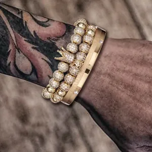 Detail of gold crown bead bracelet set and Forever Love engraved stainless steel bangle