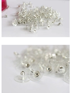 Macro view of silver bullet ear backings with clear plastic safety pad for stud earrings