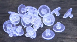 Macro shot of clear plastic disc earring backs and butterfly nut findings for jewelry
