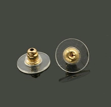 Macro view of transparent plastic disk earring backs with gold plated metal core inserts