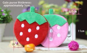 Macro view of strawberry plush coin purse details with green leaves and metal chain