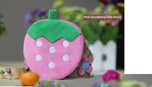 Detailed view of pink plush strawberry coin purse with green leaf handle and bead chain