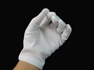 Close-up of white cotton gloves for magicians or formal wear against black background
