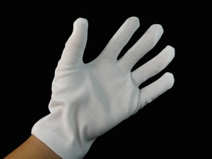 Detailed texture of white magician gloves for Halloween costumes on a black background