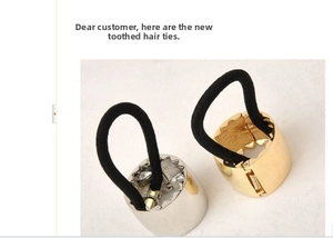 Detail showing gold and silver serrated metal clasps with springs on black hair ties