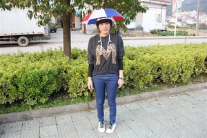 Detail of red, white and blue head-mounted umbrella hat for outdoor sun protection