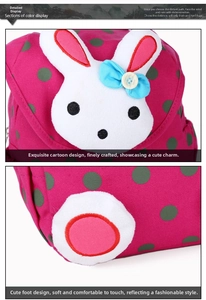 Detailed close-up of rabbit embroidery and green polka dots on pink canvas backpack