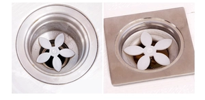 Close-up of white flower-shaped drain hair catcher in square and round metal sink filters