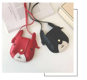 Detail shot of cute animal themed mini PU leather crossbody bags for girls in red and black
